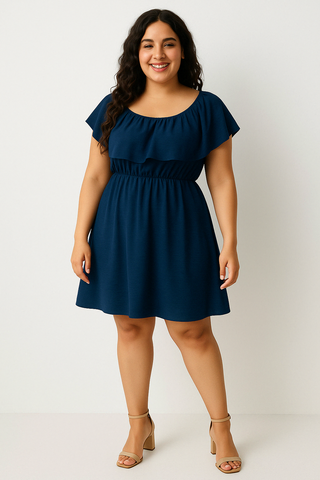 Plus size woman wearing a navy blue flutter sleeve mini dress with elastic waist and ruffle detail